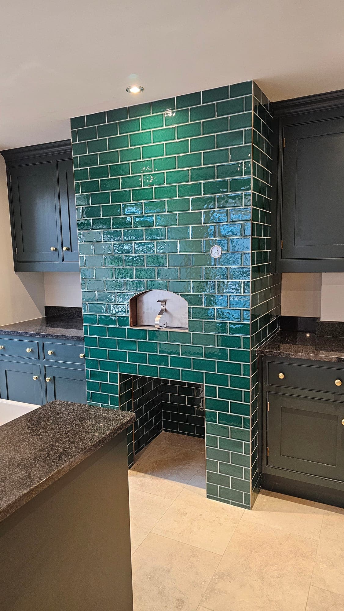 Range alcove lined in hand-glazed green tiles