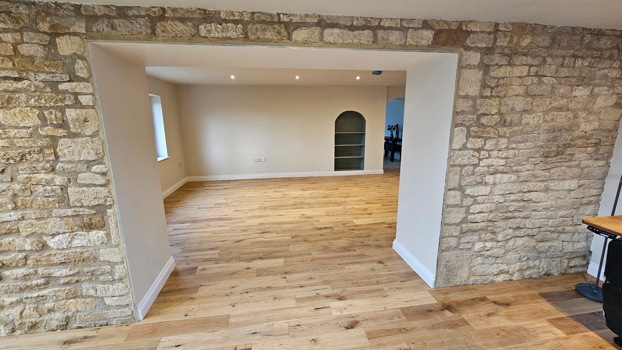 Arched openings cut through the exposed stone wall