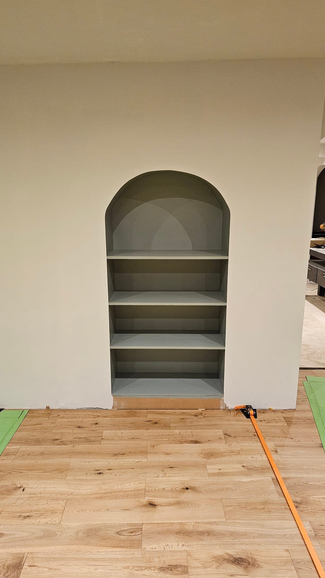Arched alcove with shelving, painted