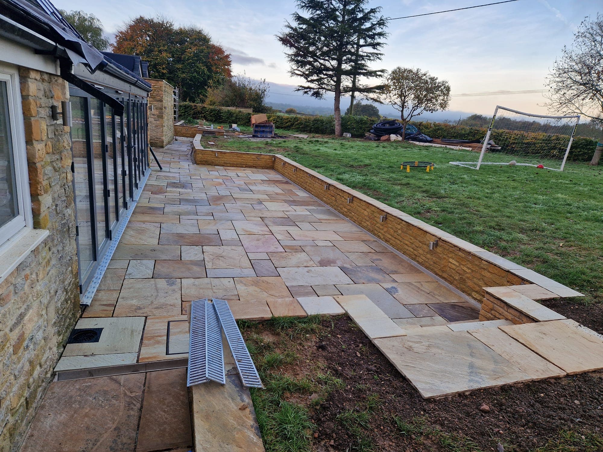 Sandstone terrace and retaining wall looking out to the fields