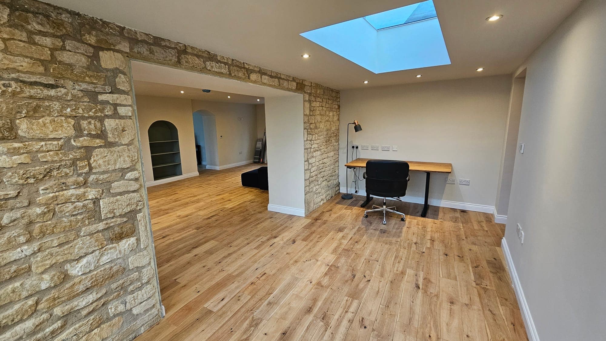 Exposed stone wall and roof light in the renovated wing
