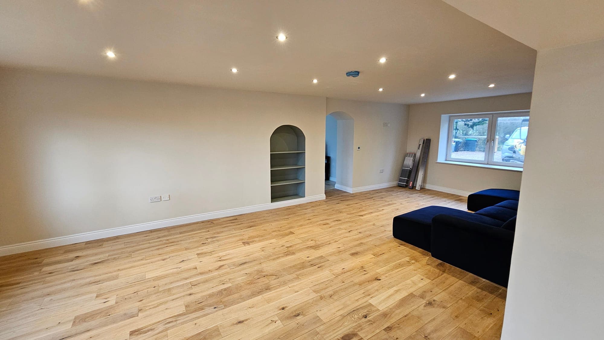 Sitting room with arched alcoves either side of the chimney breast