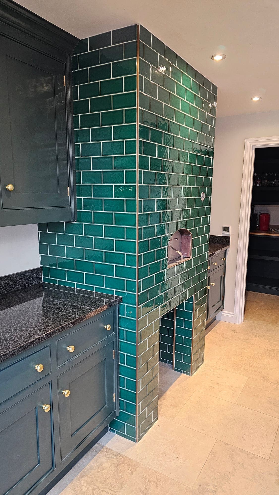 Hand-glazed green tiles and the copper hood