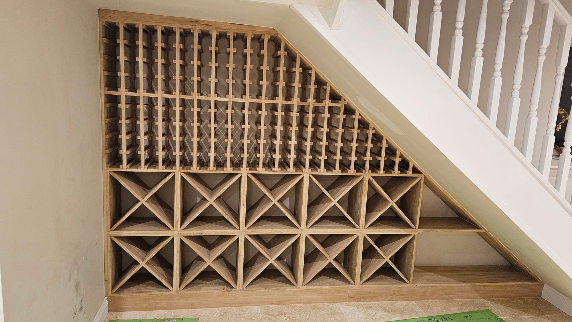 Wine store lattice under construction beneath the stairs