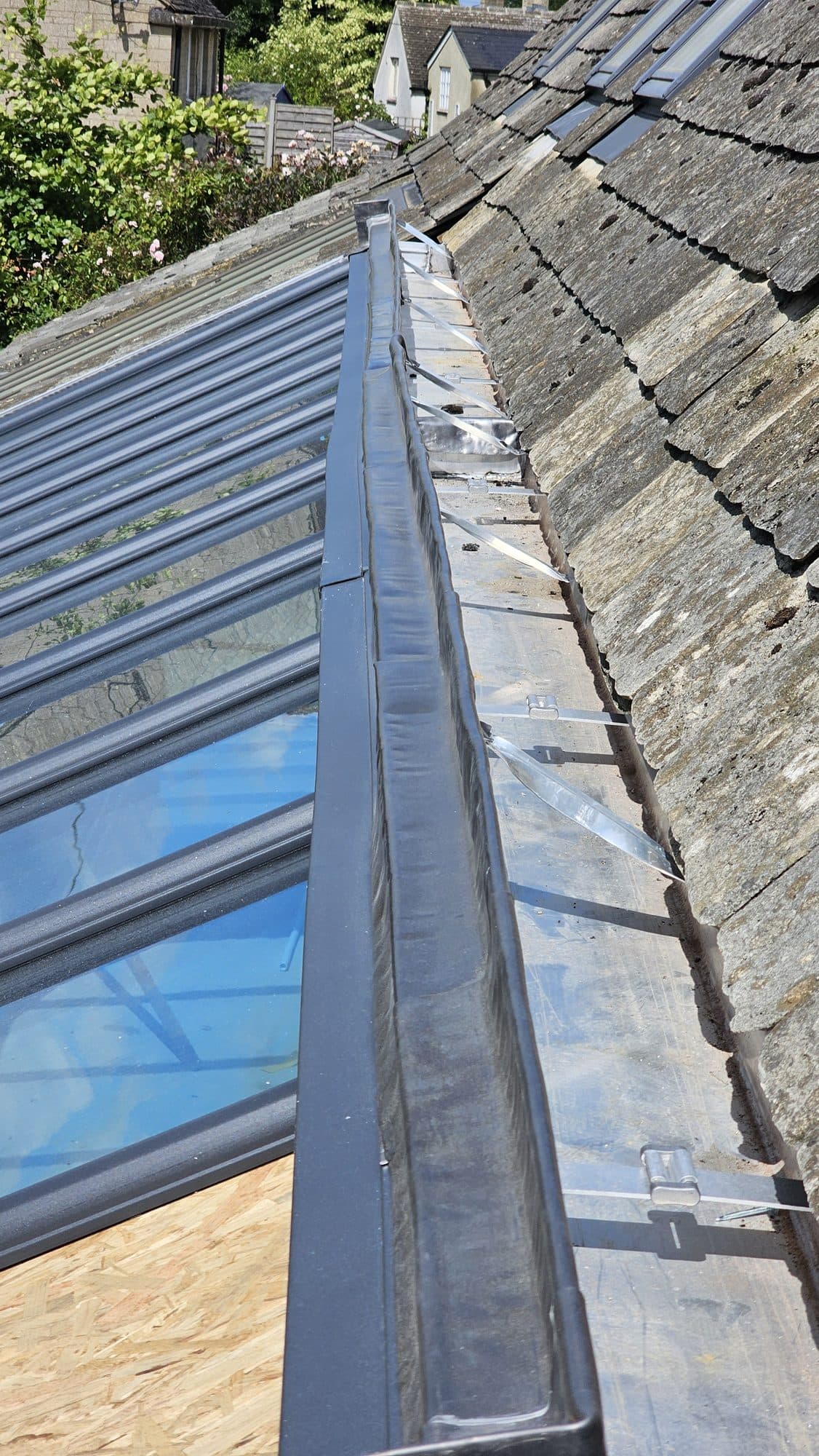 Flashing dressed where the glazing meets the stone slates